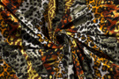 Dierenprint stoffen - Tricot stof - bedrukt dierenprint - zwart oranje oker - 18138-069