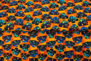 Oranje stoffen - Tricot stof - French Terry - digitaal monstertrucks - oranje - 24509-13